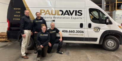 Paul Davis Restoration of Greater Missoula team standing beside a branded restoration service van.
