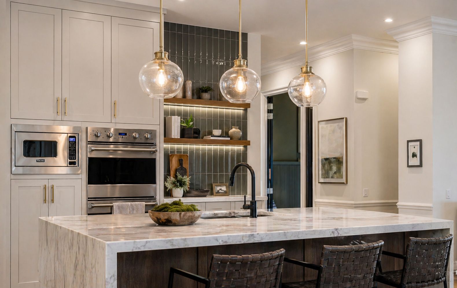 Modern kitchen with marble island, pendant lighting, built-in appliances, and tile backsplash showcasing custom kitchen restoration and upgrades in Greater Missoula.